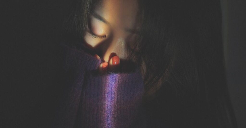 静かにうつむく女性。「私のせいかも」という言葉が、心に重くのしかかる瞬間。