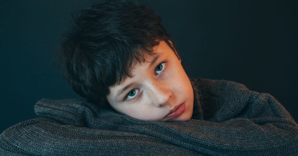 やわらかな光の中で静かに受け入れられる少年。言葉がなくても、気持ちが届く瞬間がある。