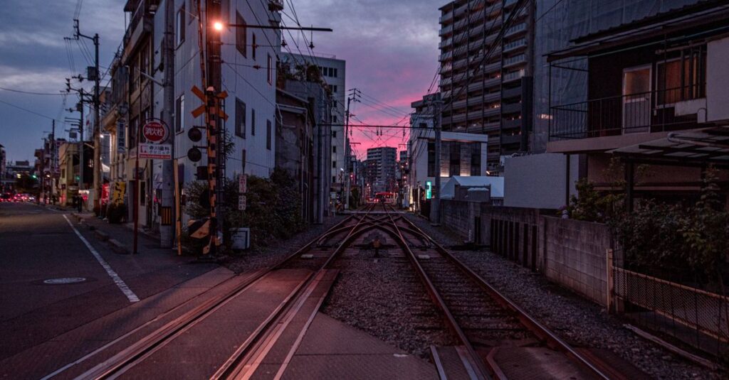 夕暮れの分かれ道に立つ旅人。いくつもの未来を想像できる心を象徴する風景。
