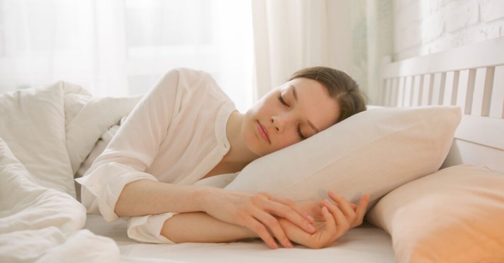 やわらかな光の中で静かに休む女性。自分を補充することで次の優しさが生まれる安堵の風景。