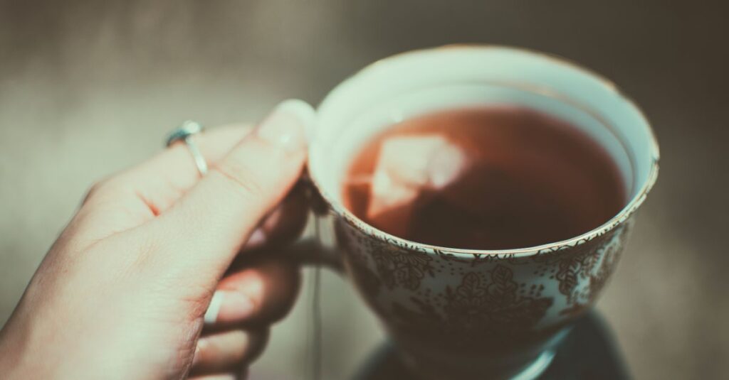 gentle hands holding warm cup quiet safety calm light