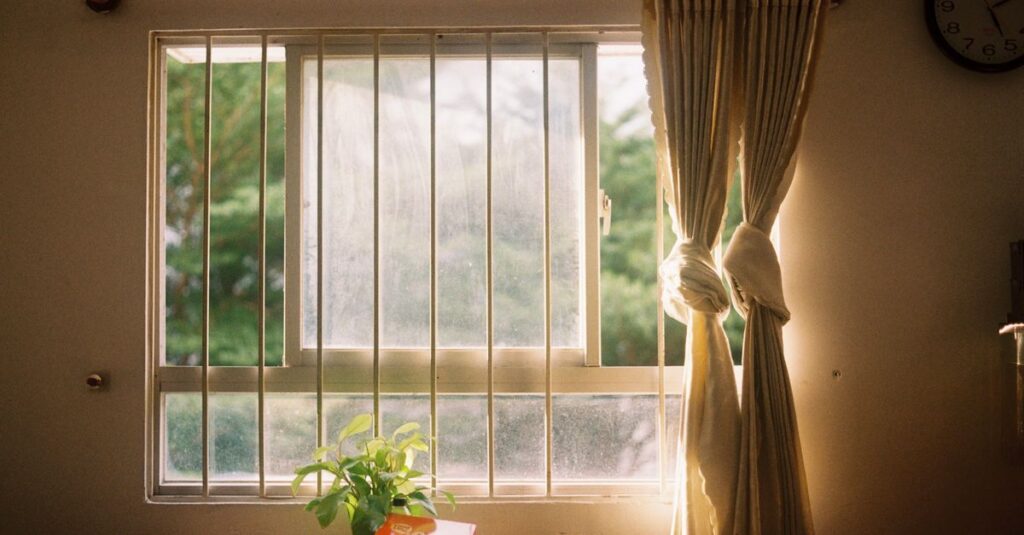 quiet window dusk soft curtain calm pause atmosphere