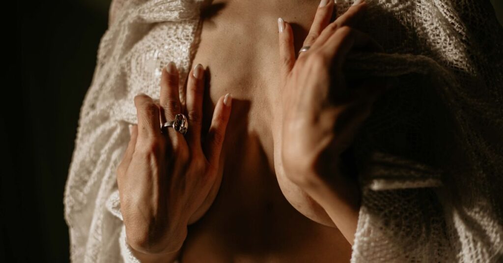 gentle hands near chest warm dim light