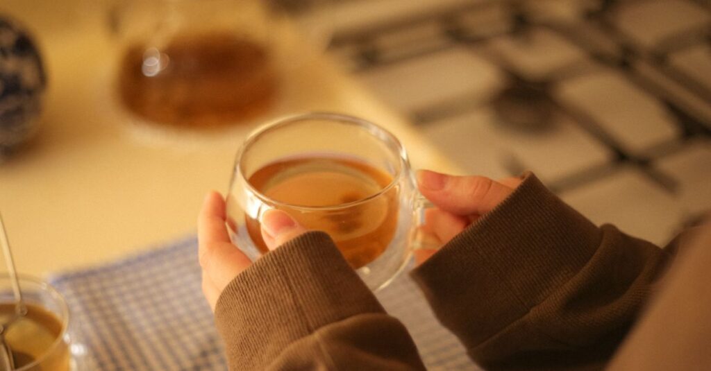 soft hands holding warm cup quiet room gentle light
