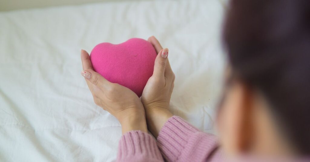 gentle hands near heart soft light self respect calm