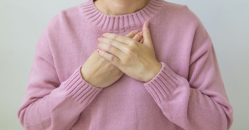 gentle hands near heart quiet self awareness soft room
