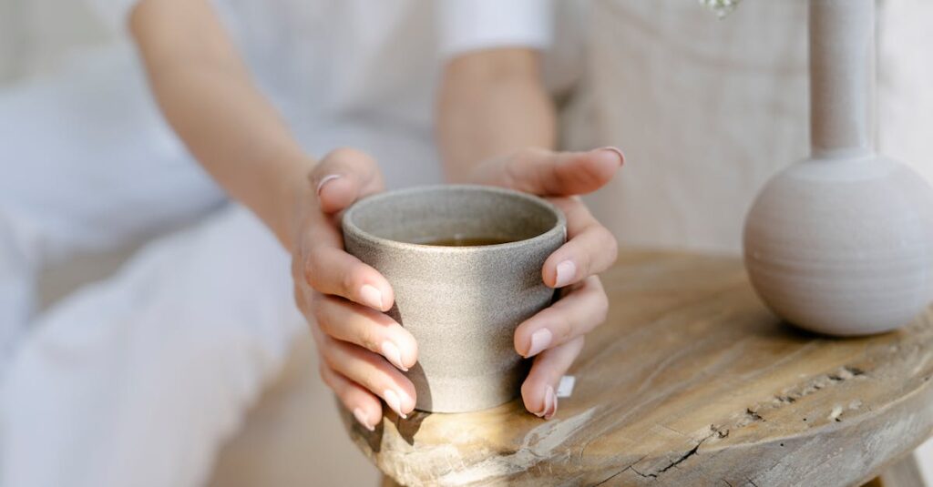 gentle hands holding warm cup quiet safety calm light