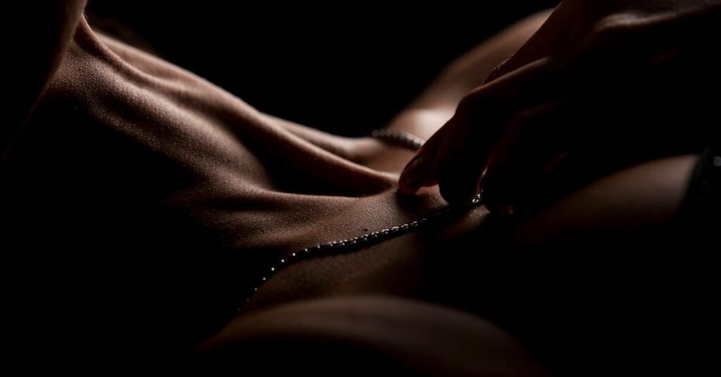 gentle hands near chest warm dim light