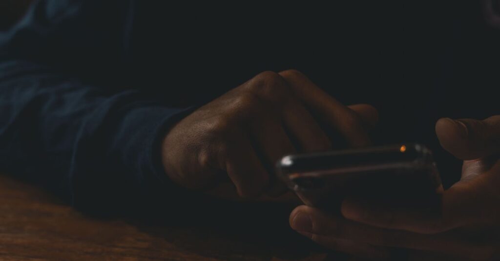 scrolling phone comparison feeling quiet night self doubt soft light