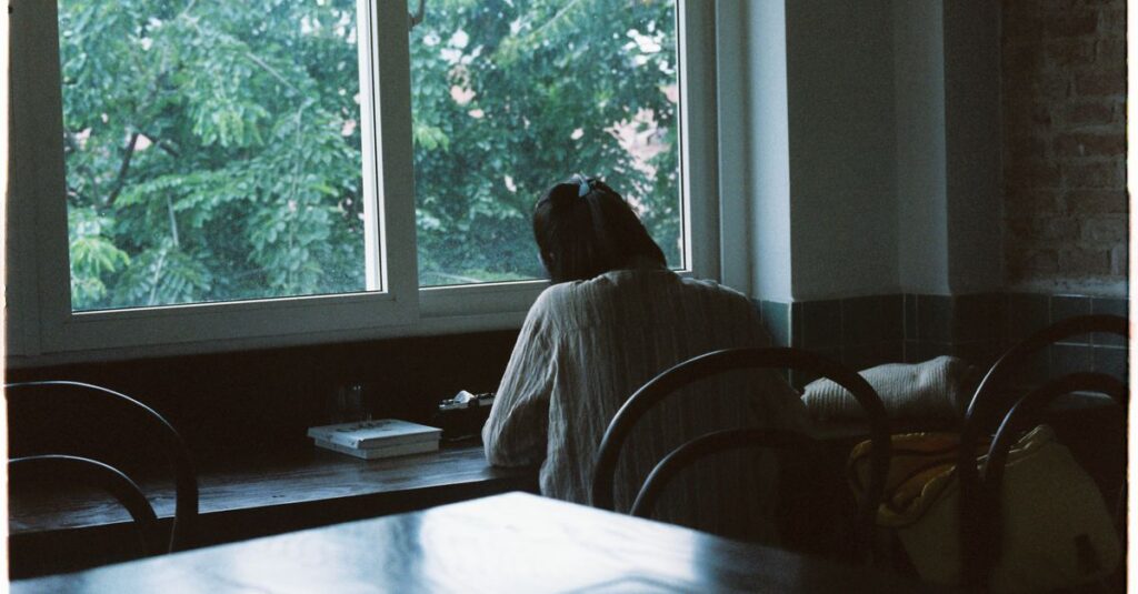 soft window light notebook quiet reflection gentle atmosphere