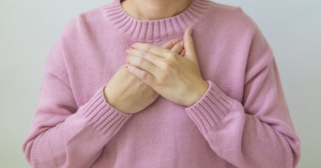 gentle hands near chest soft light self protection calm