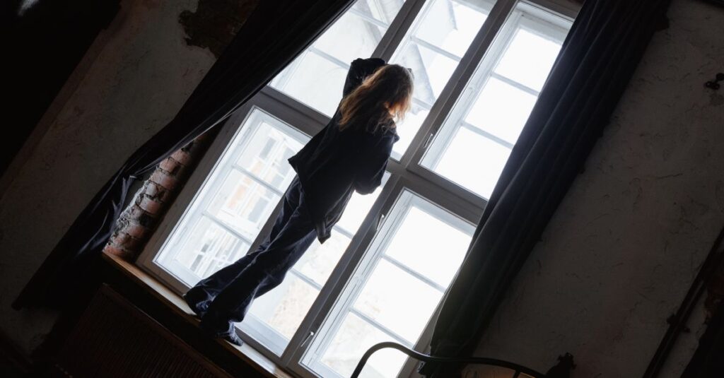 woman alone night window soft light empty quiet exhausted fulfilled outside hollow inside