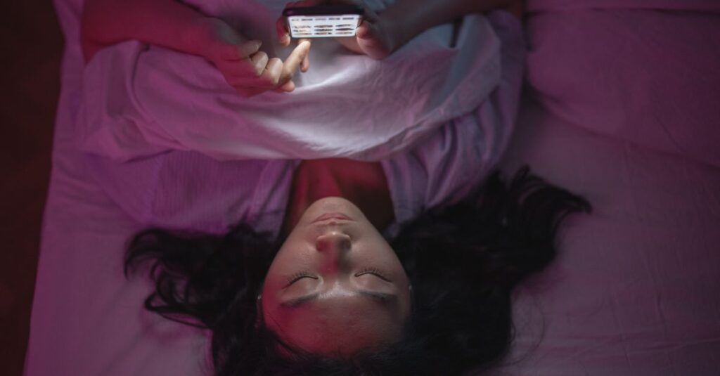 scrolling phone comparison feeling quiet night self doubt soft light